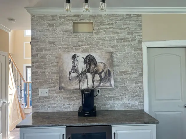 67bca26f1f907_image1 A painting of a horse on the wall above a counter.