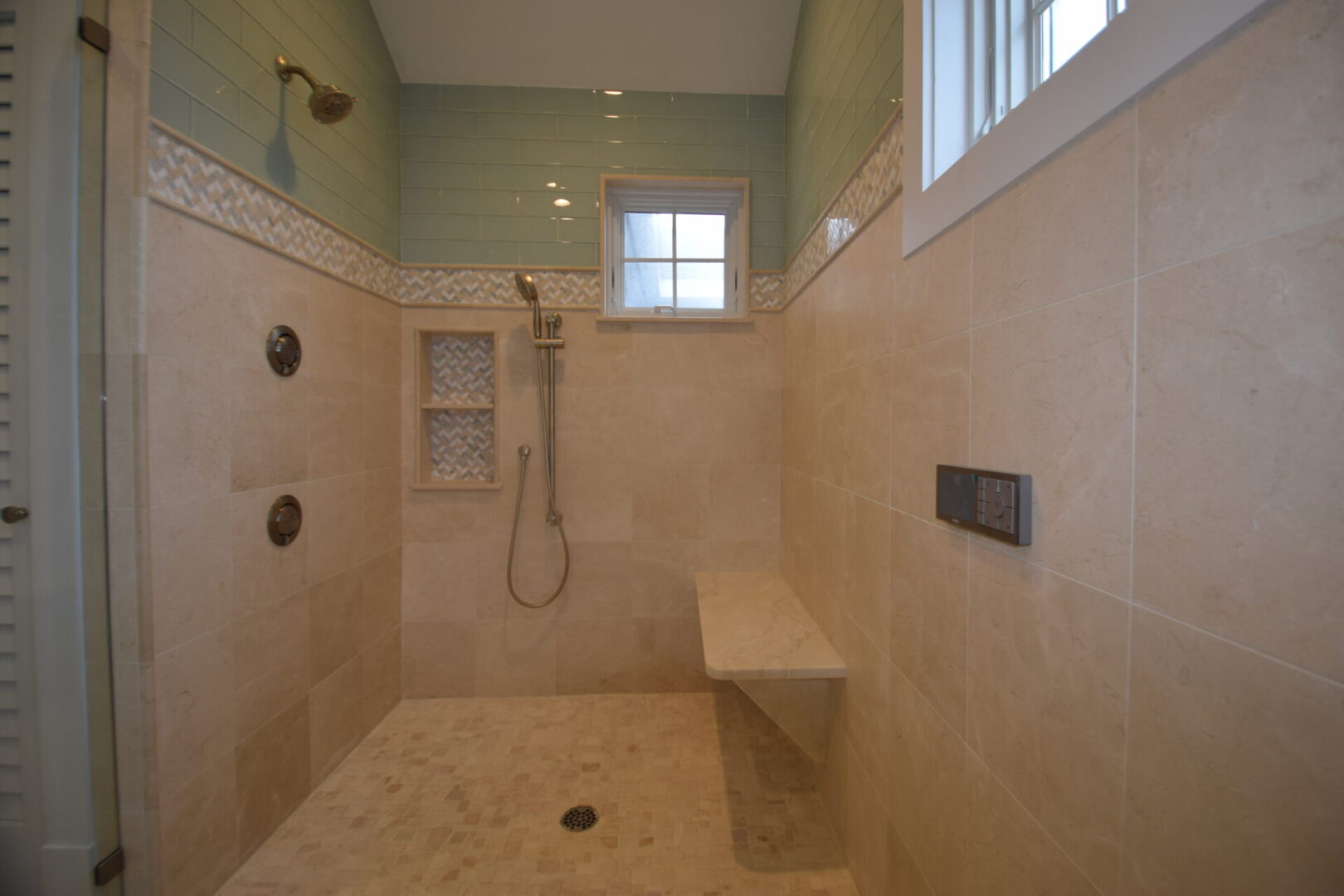 67bc9fc93b1ee_DSC_0129 A bathroom with a bench and shower stall.